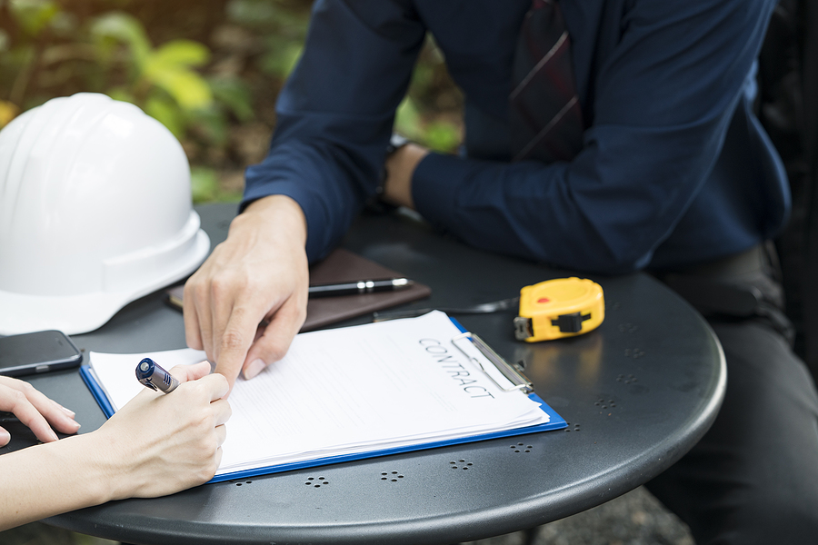 homeowner going over a detailed proposal and signing a contract